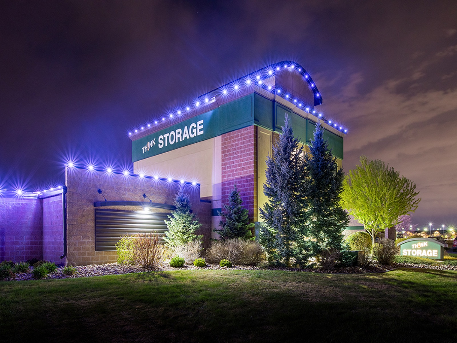 Cool white permanent roofline lighting on a storage facility