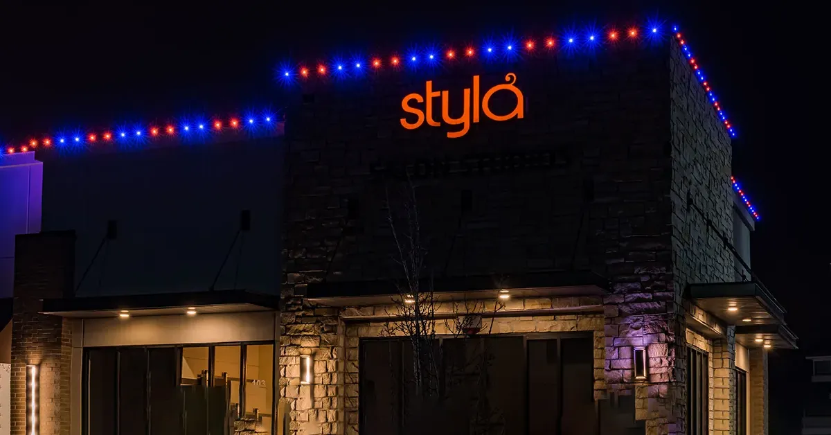 Retail storefront with blue and magenta permanent lighting