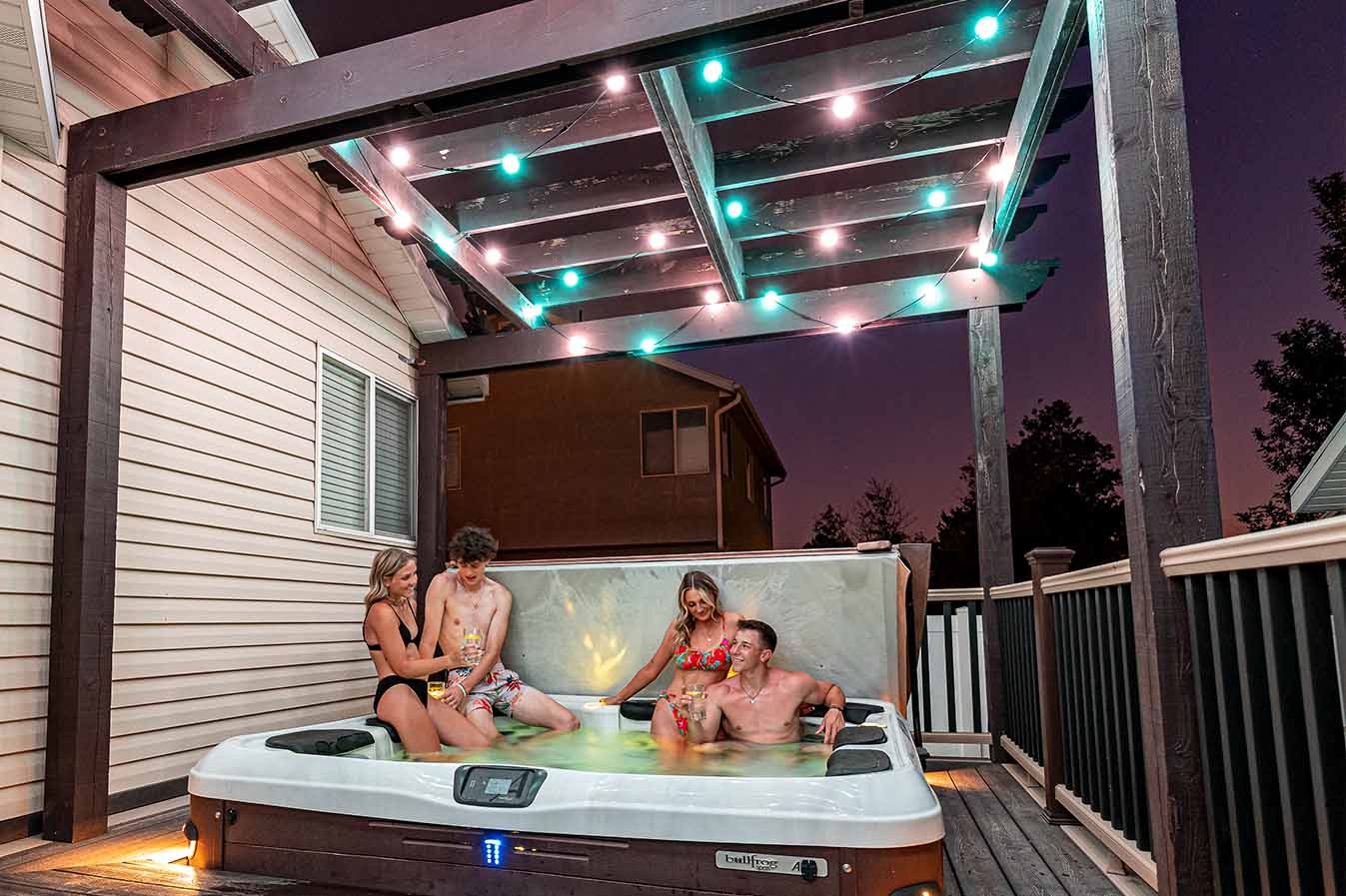 Residential hot tub beneath permanent globe lights