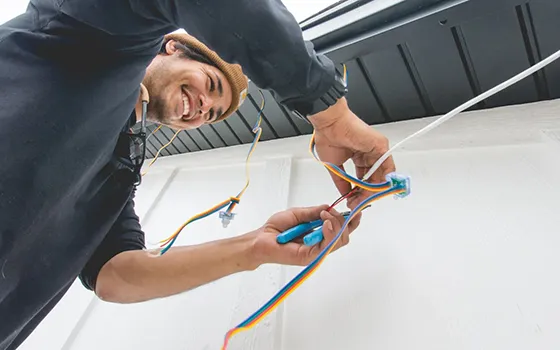 Installer completing permanent lighting wiring