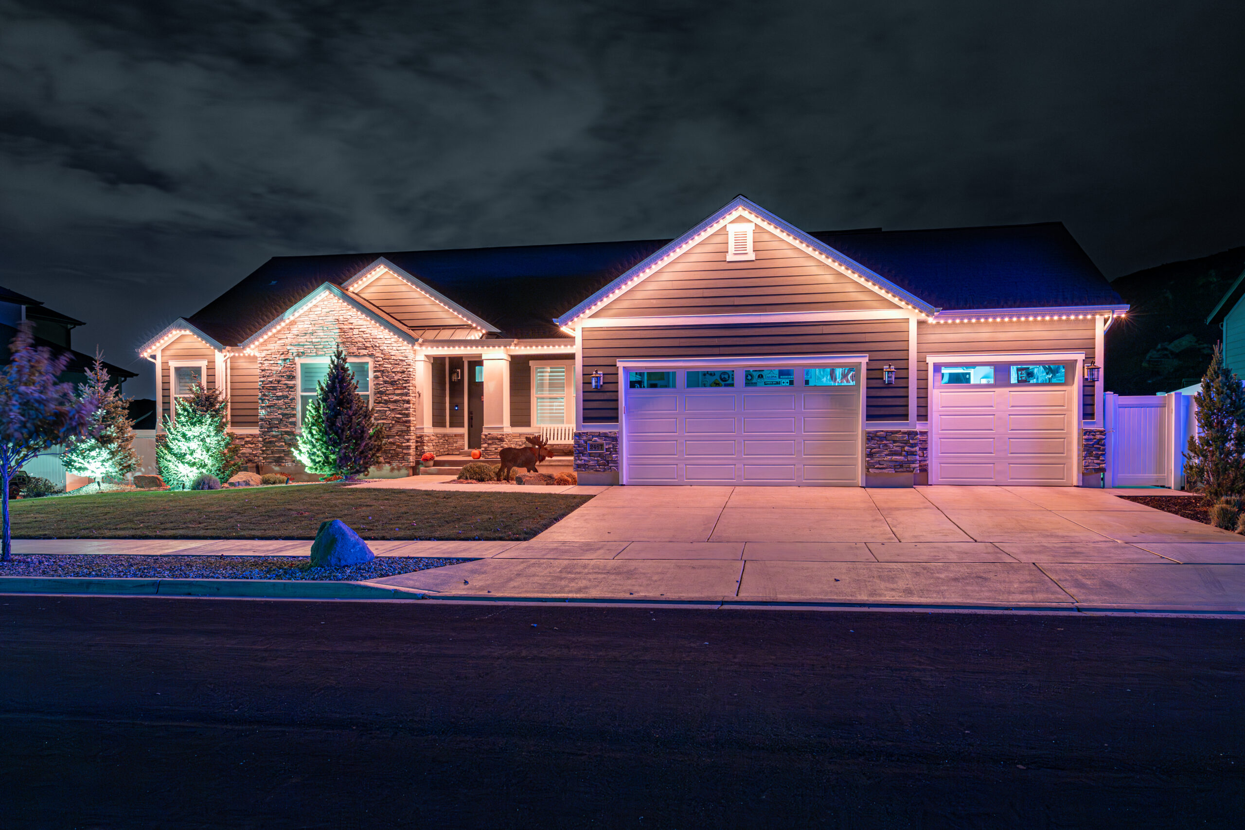 Wide single-story residential roofline with warm white lighting