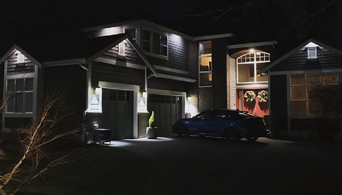 Residential home with selected garage and entry lighting zones illuminated